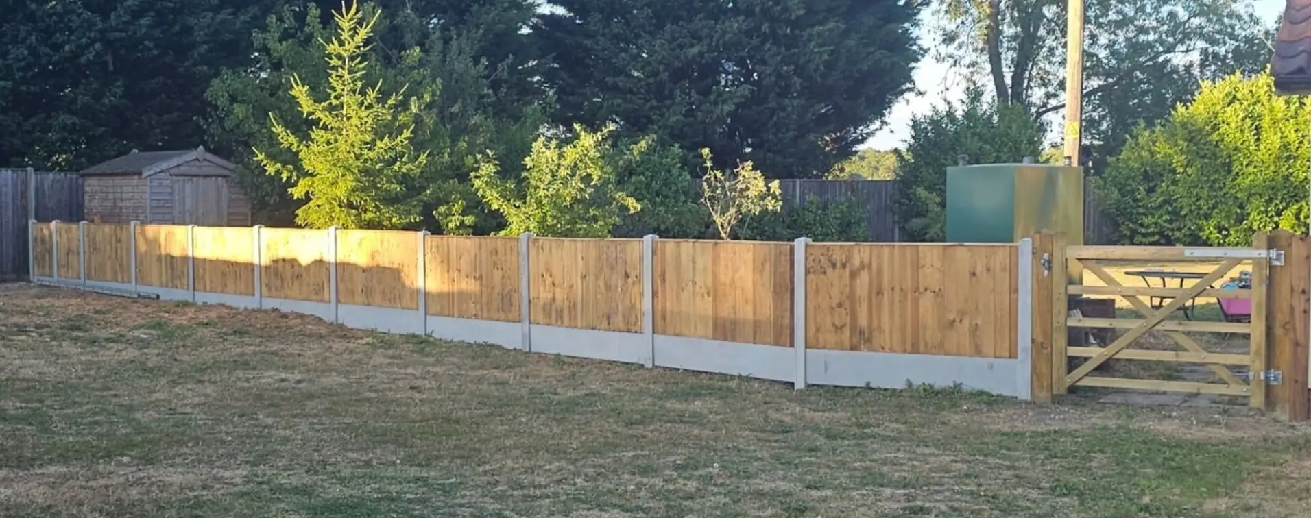 A new closeboard fence on concrete posts with a timber field gate, built by C.H.L Landscaping Services